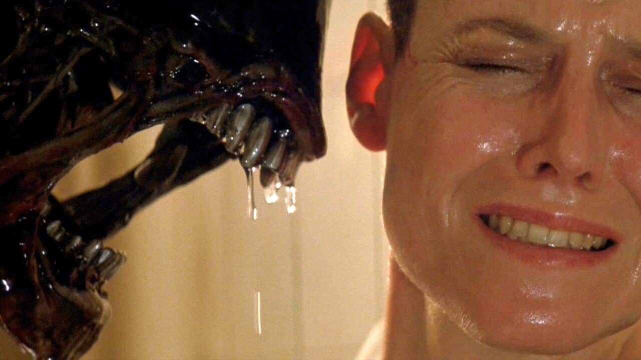 Close-up from Alien 3 showing a xenomorph dripping saliva inches from Ripleyâs face, her eyes clenched shut in terror, capturing a moment of unbearable tension and intimacy.